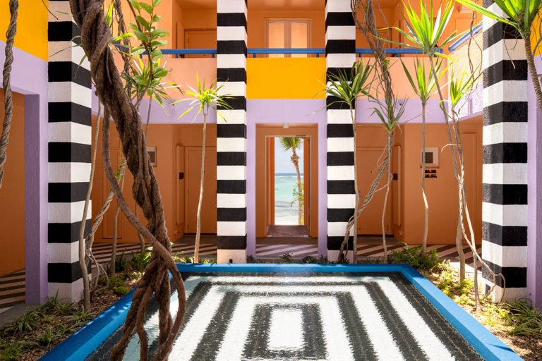 A colorful 80's style interior design hotel in Mauritus, y Camille Walala.